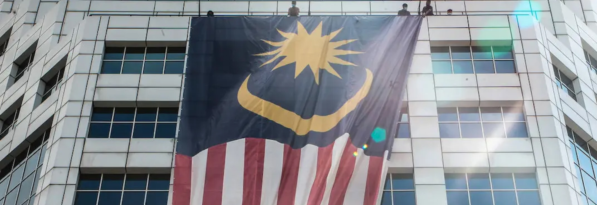 malaysia flag hanging outside a building